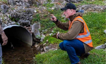 AER consultant collecting a water sample for sustainability inspection