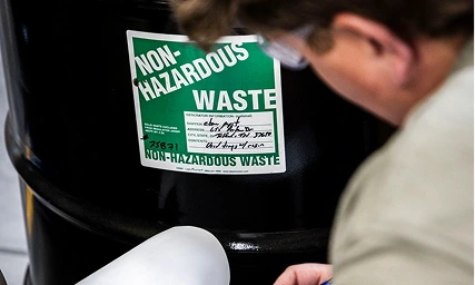 AER team member inspecting industrial non-hazardous waste