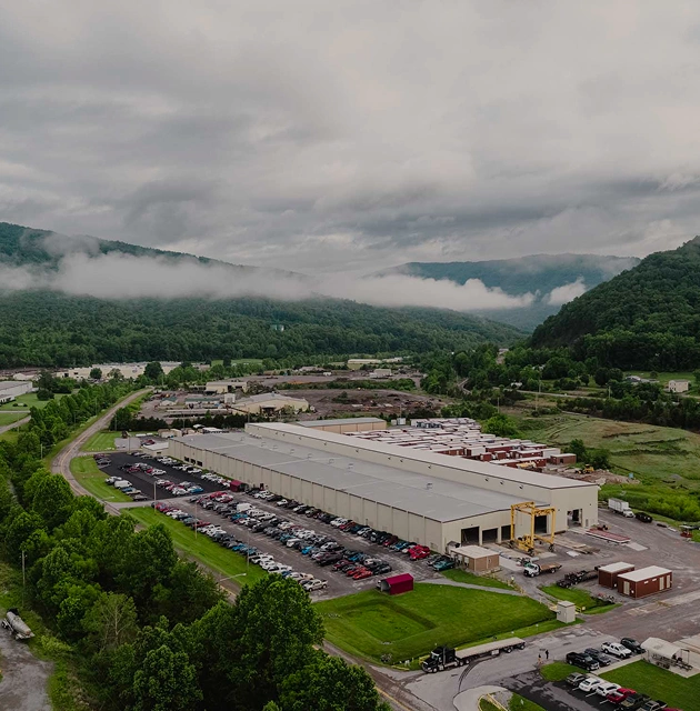 Aerial view of a large industrial manufacturing facility, an AER client site in the Appalachian Mountains
